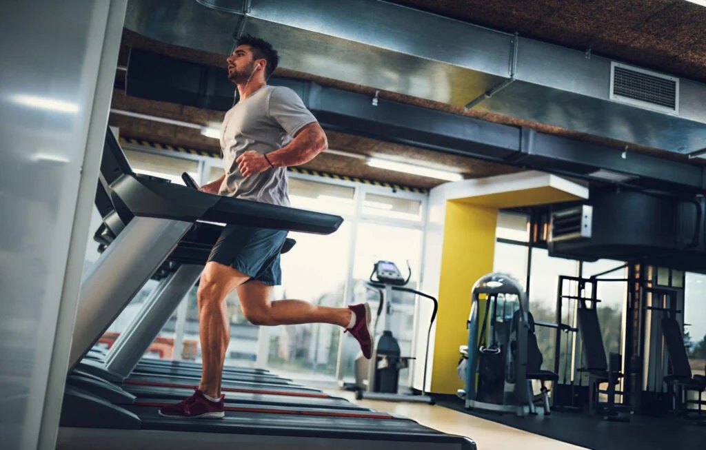 Member running on a treadmill in the cardio zone
